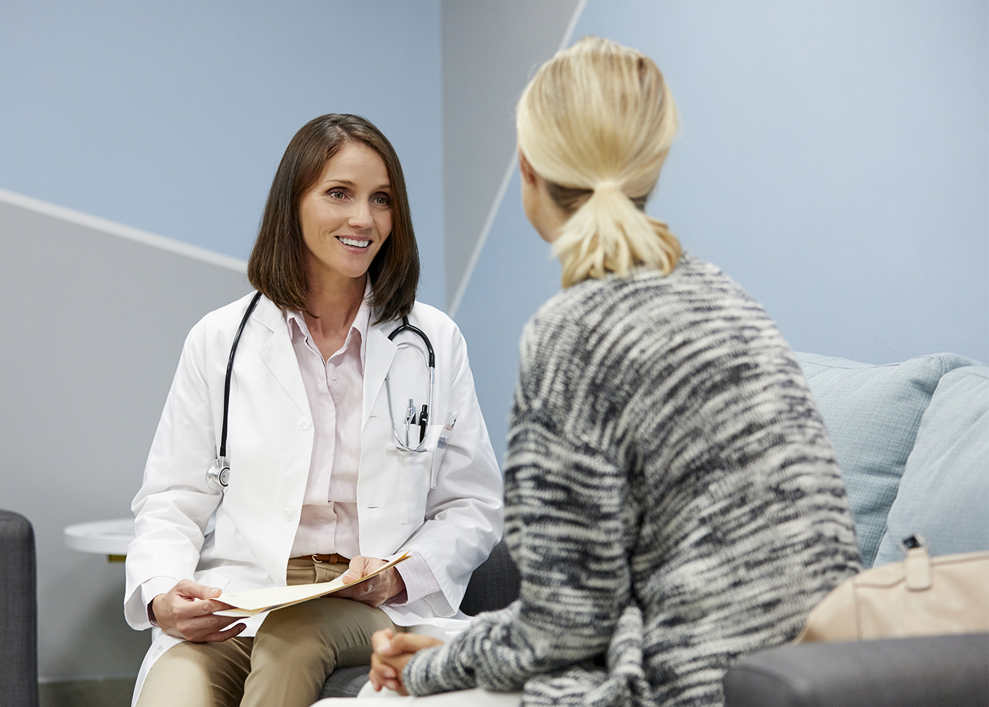 doctor talking with female patient